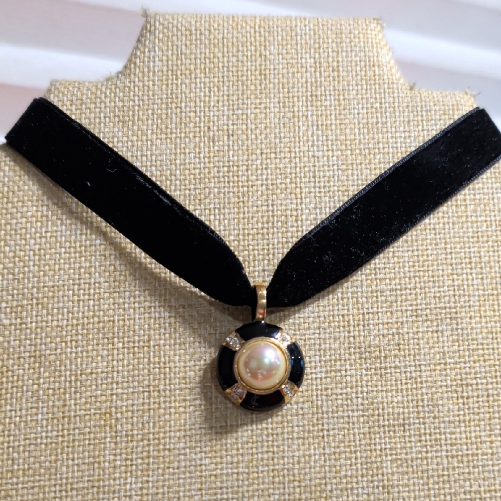black  choker necklace with a gold-tone, black enamel, and pearl pendant